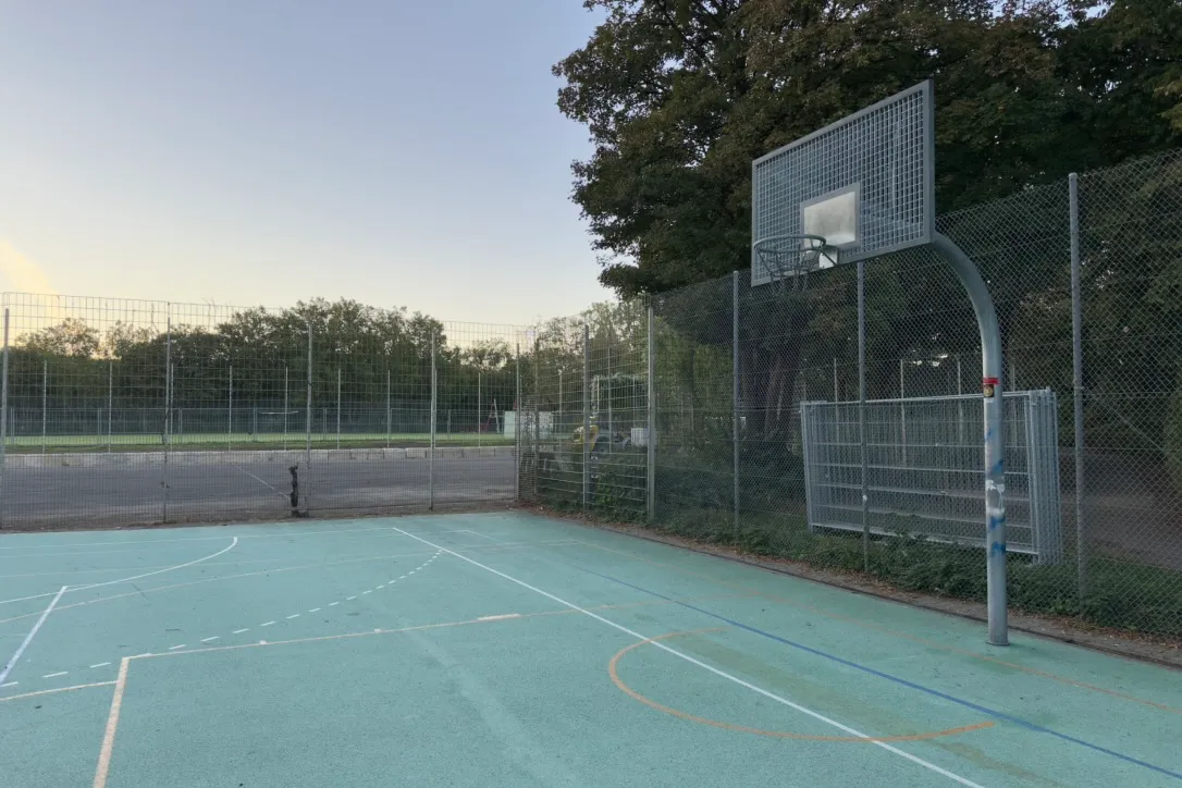 Outdoor basketball court in evening light