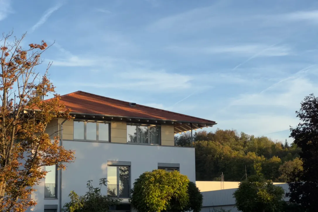 House and autumn trees in warm evening light