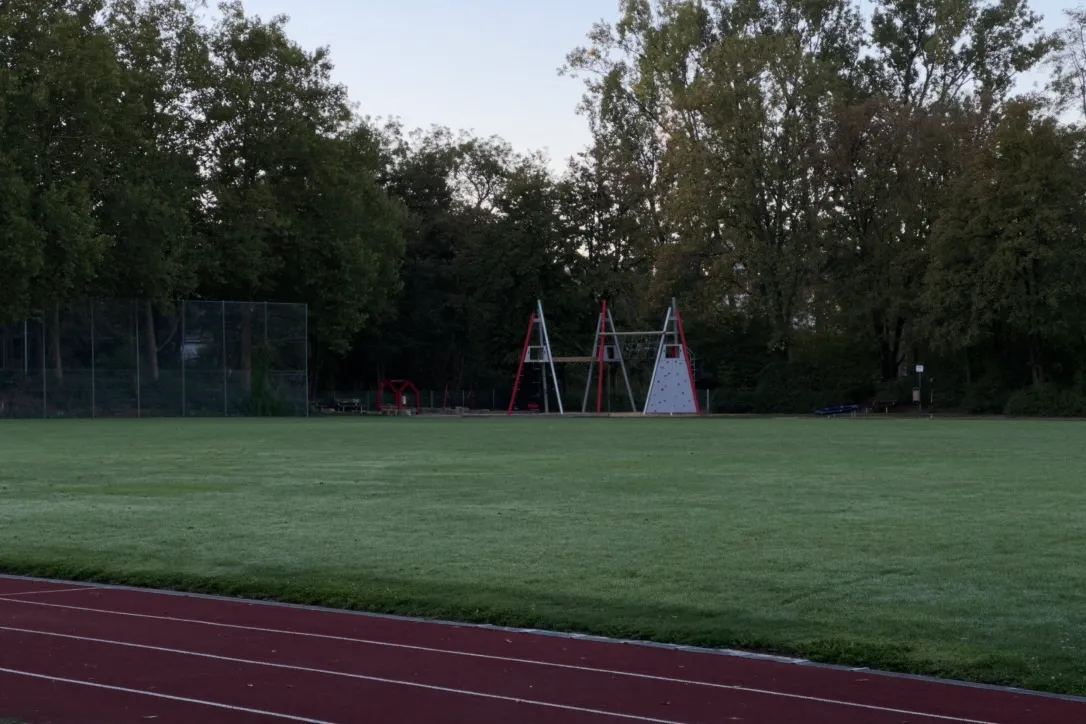 Sports field and running track at dusk